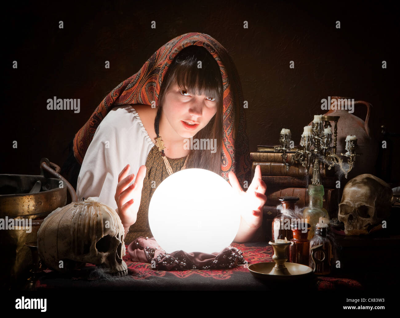 Young fortune-teller reading the future in a crystral ball Stock Photo