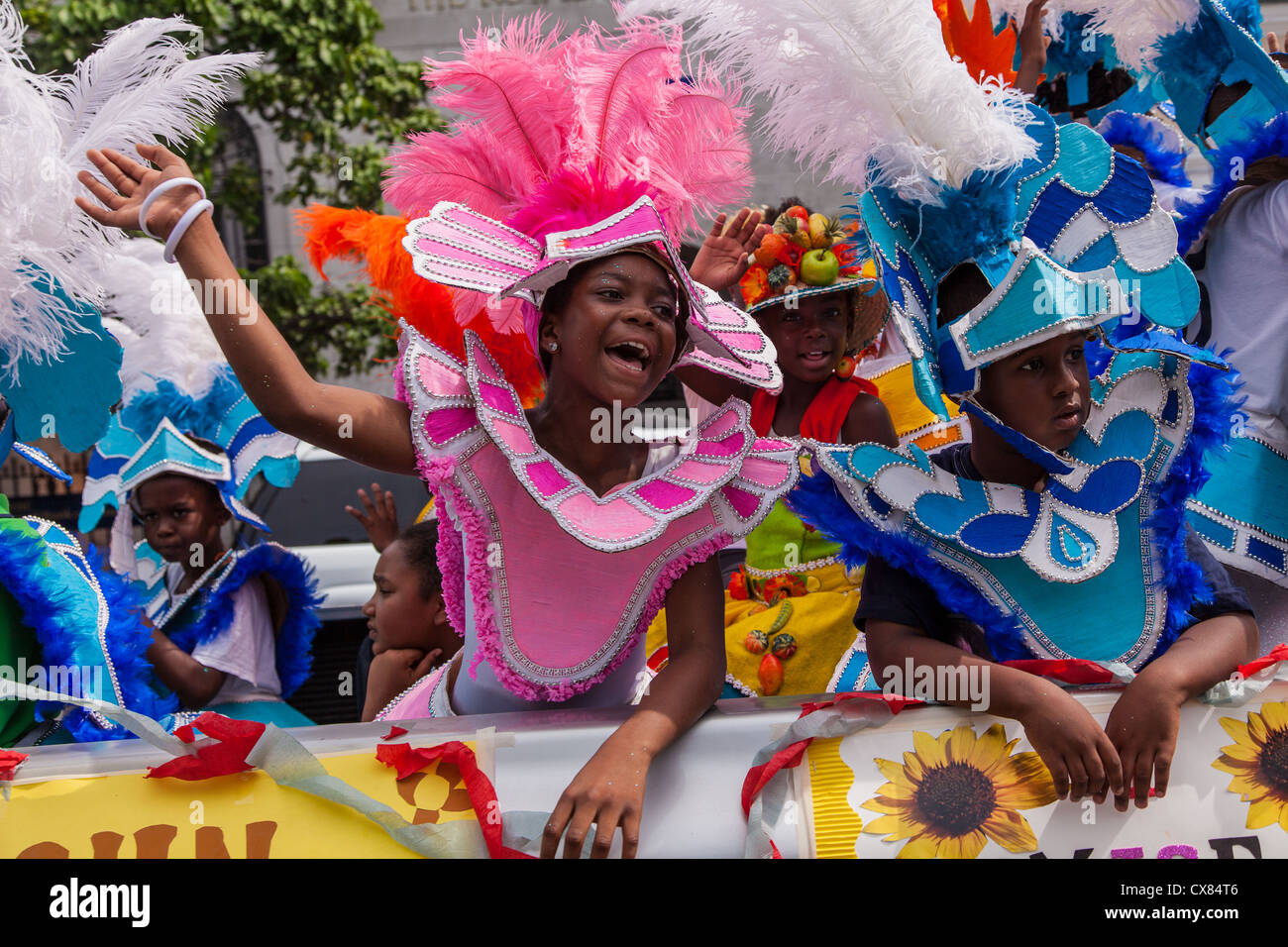 Young Bahamian girls dressed in Junkanoo costumes celebrate graduation in Nassau , Bahamas. Stock Photo