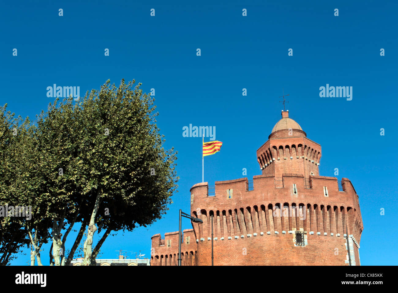 The castle (Castilet) of Perpignan flying the Catalan Flag, Languedoc Rousillon, South West France Stock Photo