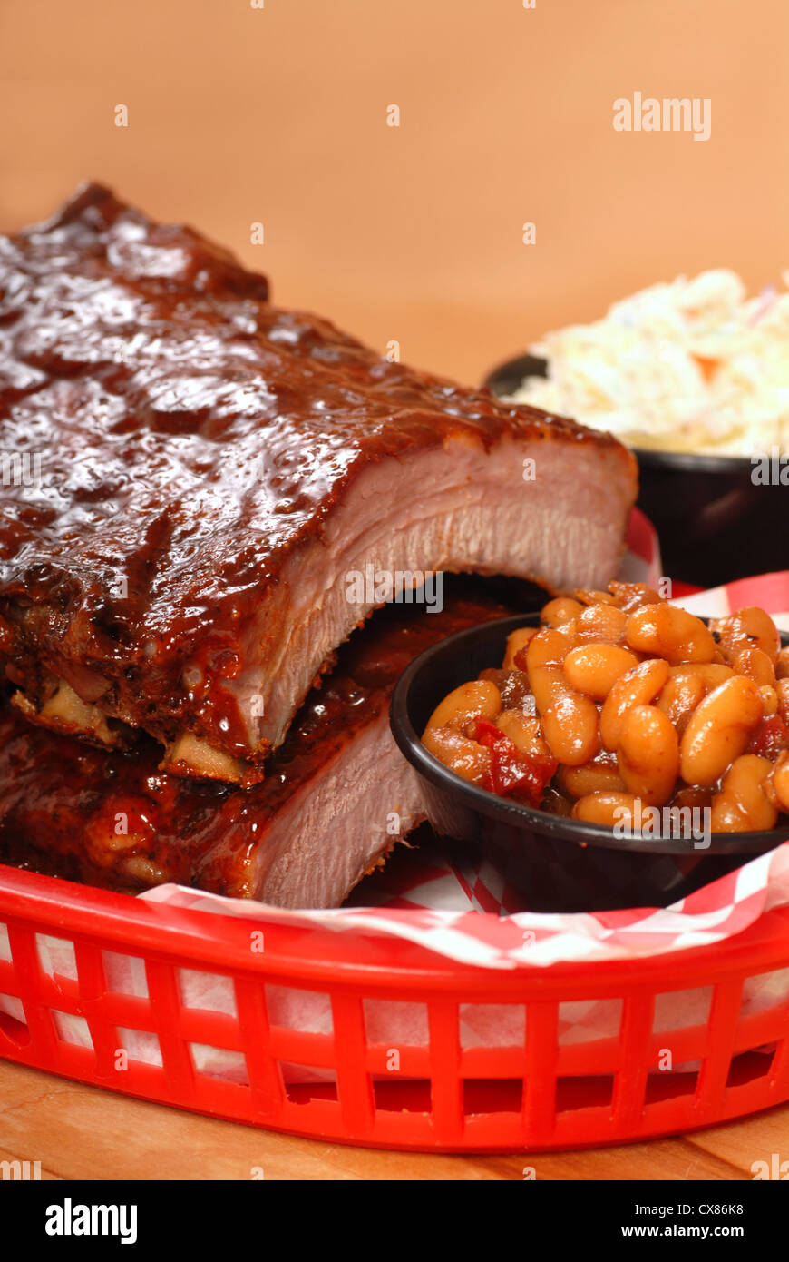 Delicious BBQ ribs with beans, cole slaw and a tangy BBQ sauce Stock Photo