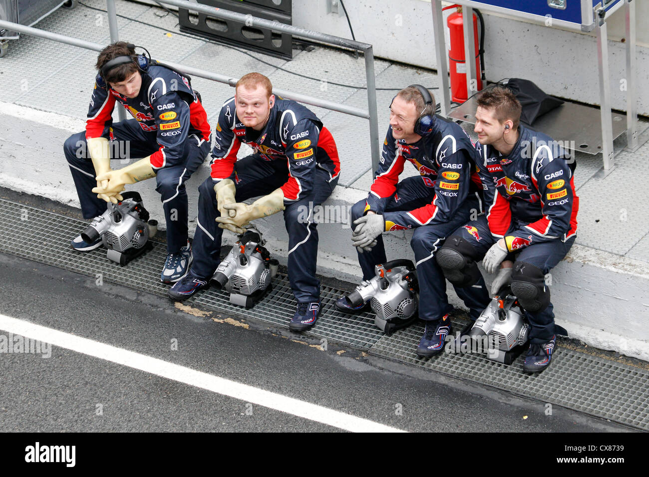 Red Bull Formula One team mechanics taking a rest in the pit lane during  Formula One testing at Montmelo, Barcelona, Spain Stock Photo - Alamy
