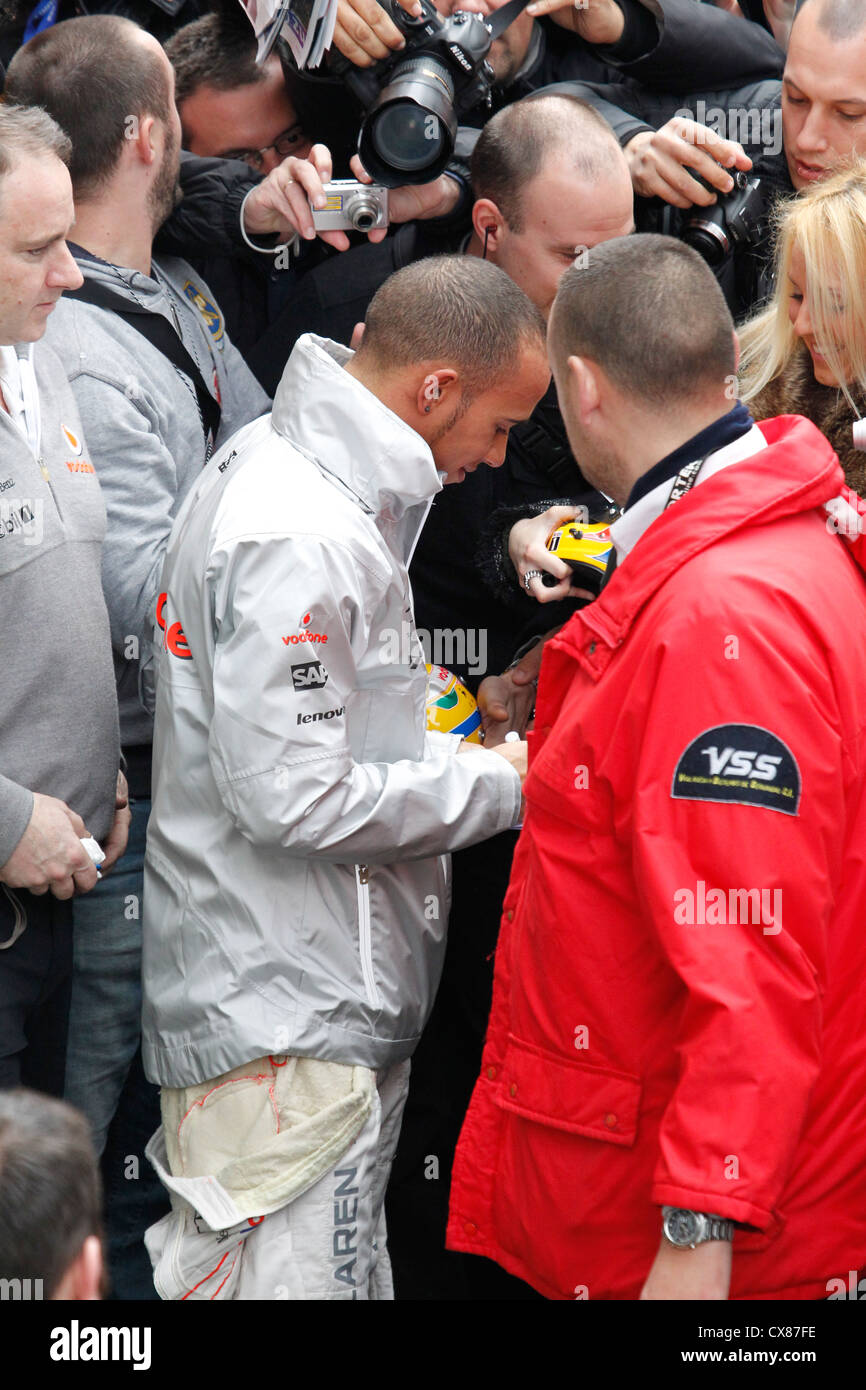 Mclaren Formula One racing driver Lewis Hamilton signing autographs ...