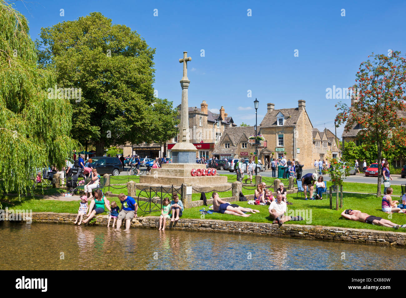 Cotswolds village of Bourton on the water with Tourists on The Green Bourton on the Water Cotswolds Gloucestershire England UK GB Europe Stock Photo