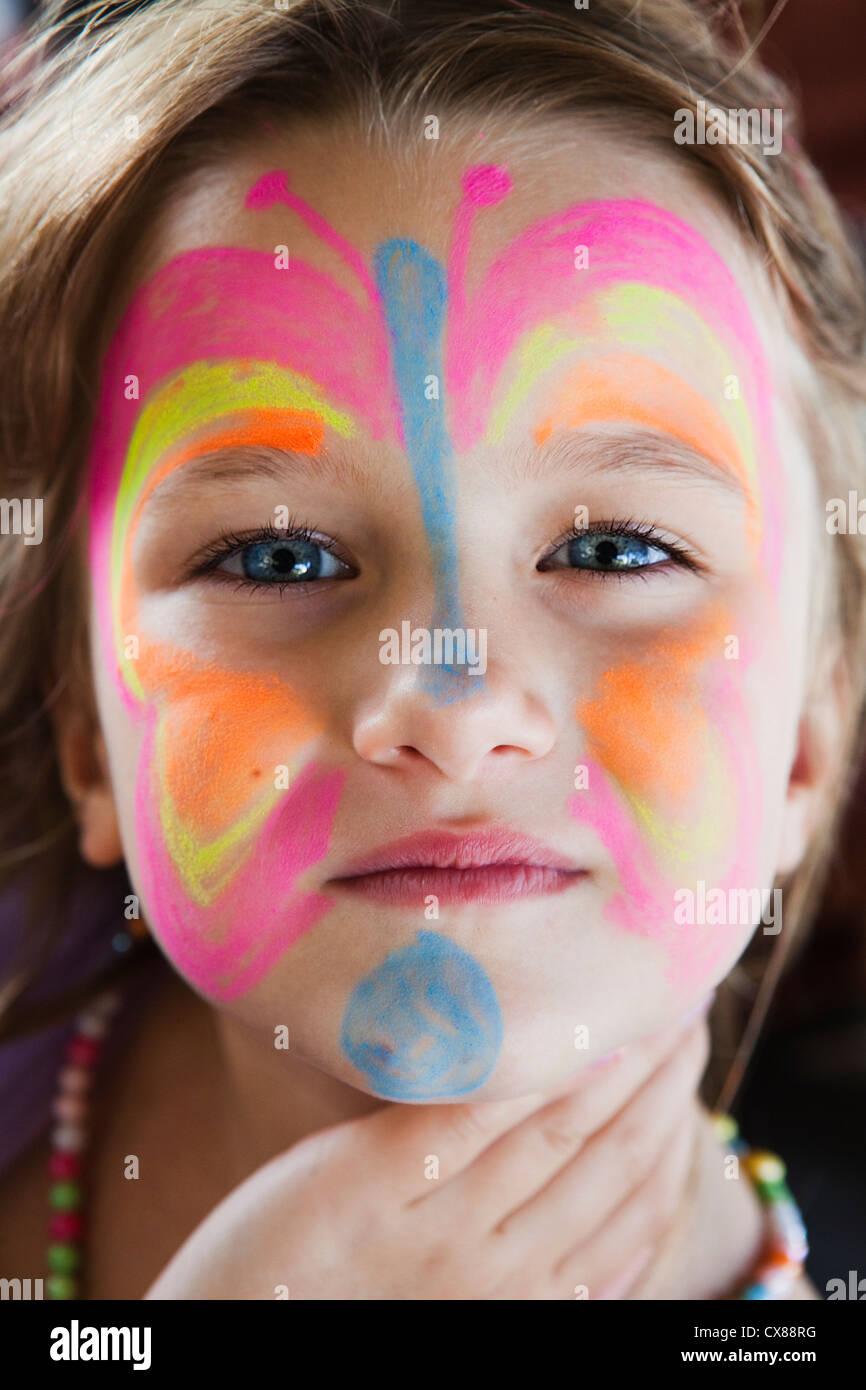 A Girl With A Colourful Butterfly Painted On Her Face; Gold Coast, Queensland, Australia Stock Photo