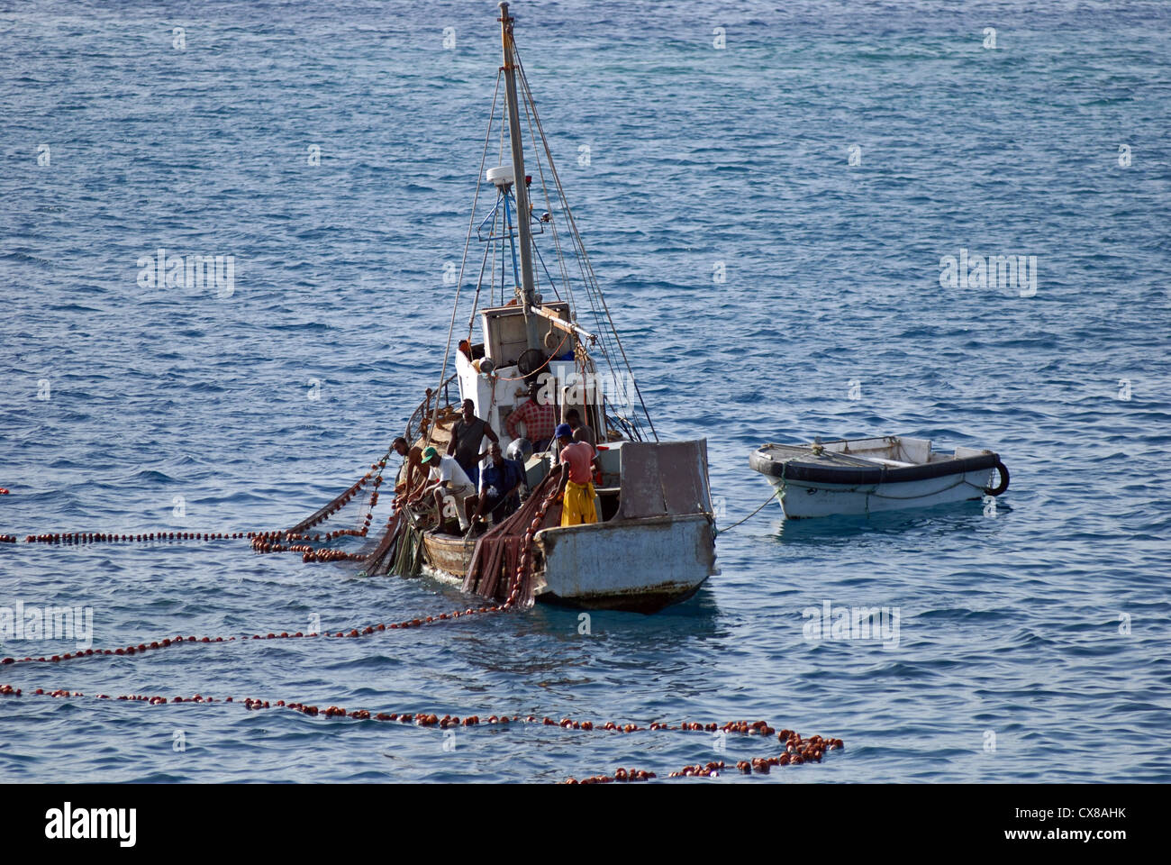 Crew on a fishing boat hauling in a purse seine net, just off the Cape Verde Islands, West Africa Stock Photo