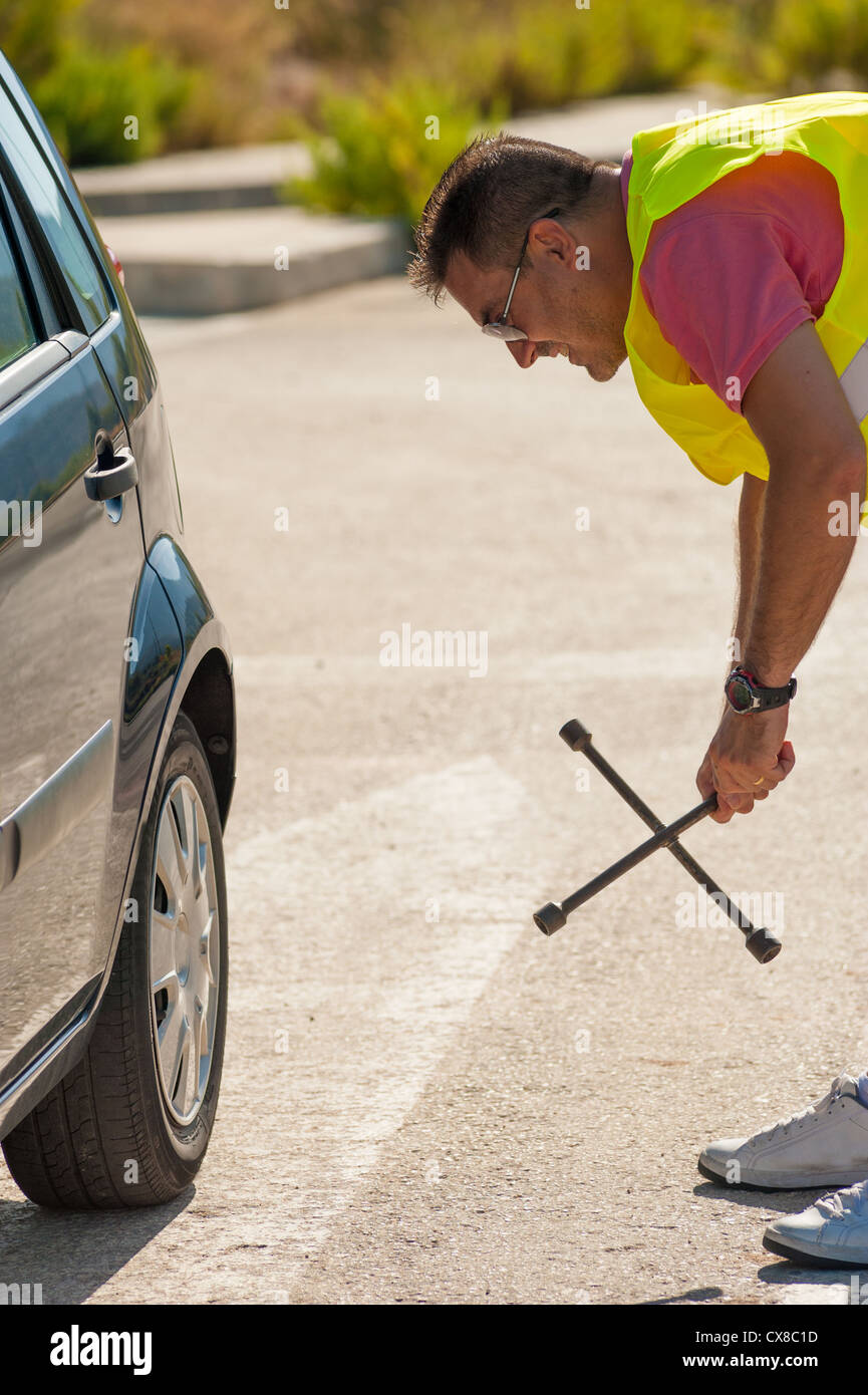Male pretty unsure about how to handle a tool Stock Photo - Alamy