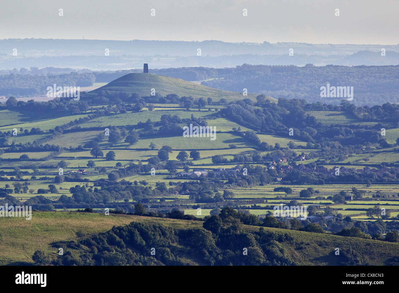 A view of Glastonbury Tor taken from the Mendip Hills looking across the Somerset Levels, UK Stock Photo