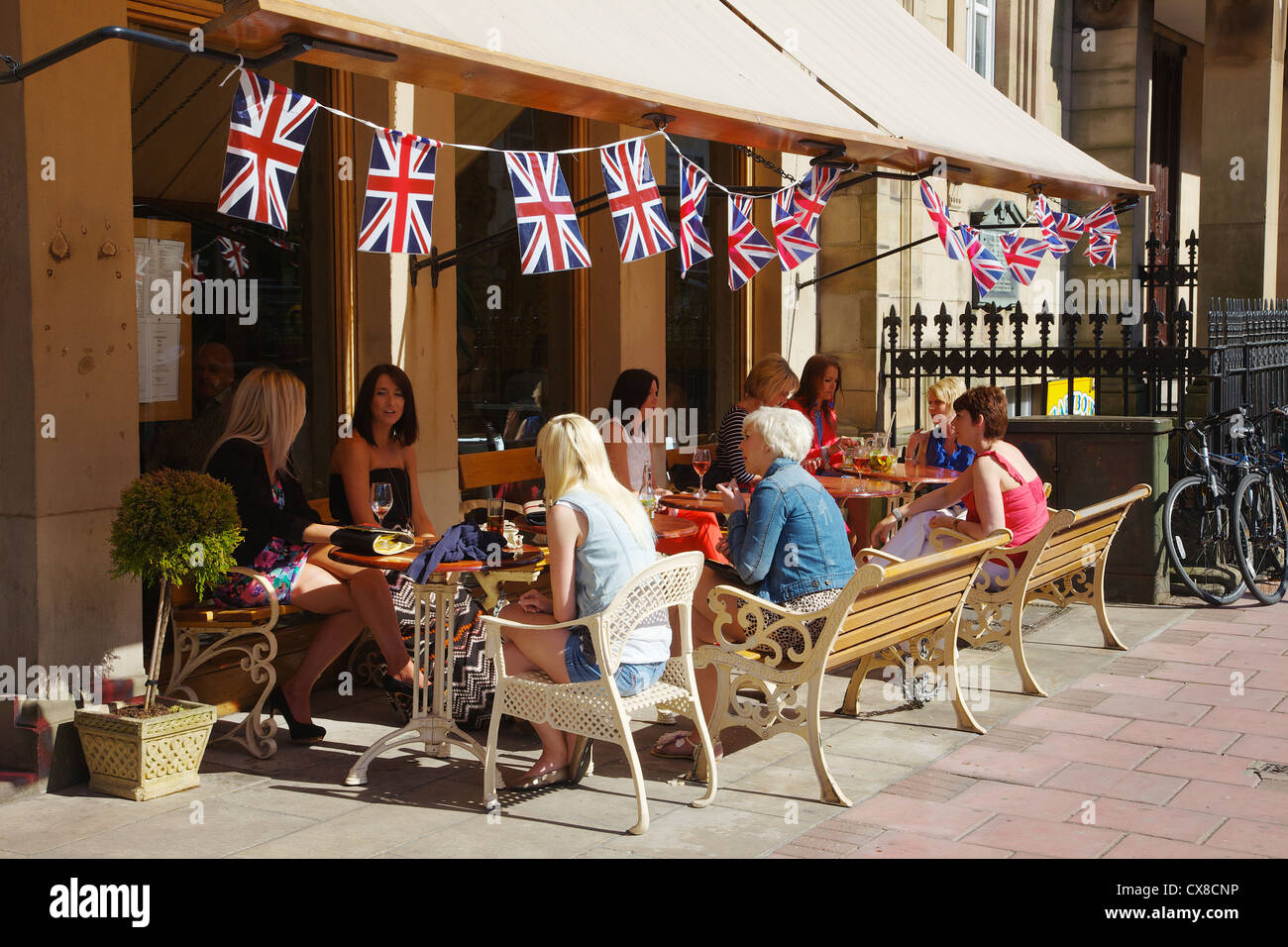 Women lunching outside a café in the city centre of Carlisle Cumbria, England UK Stock Photo