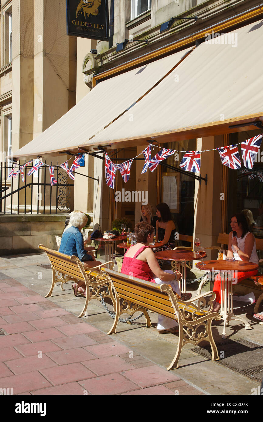 Women lunching outside a café in the city centre of Carlisle Cumbria, England UK Stock Photo