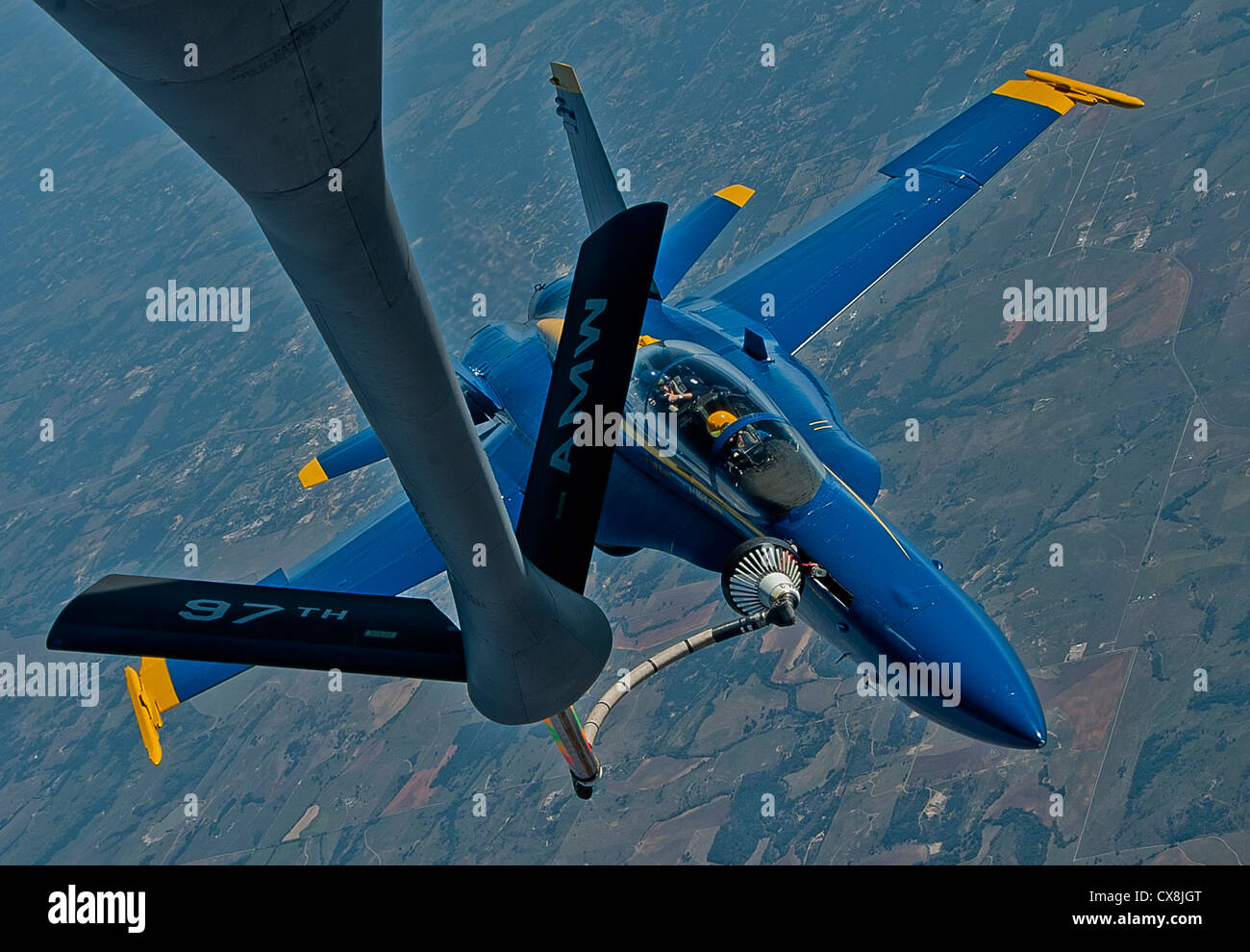 A KC-135 Stratotanker from Altus AFB refuels an Navy Blue Angel FA-18 Hornet from Naval Air Station Pensacola, Fla., Sept. 20, 2012. The Blue Angels were refueled on the way to Grand Juction, Colo., to perform in the First Mountain West Airshow. Stock Photo