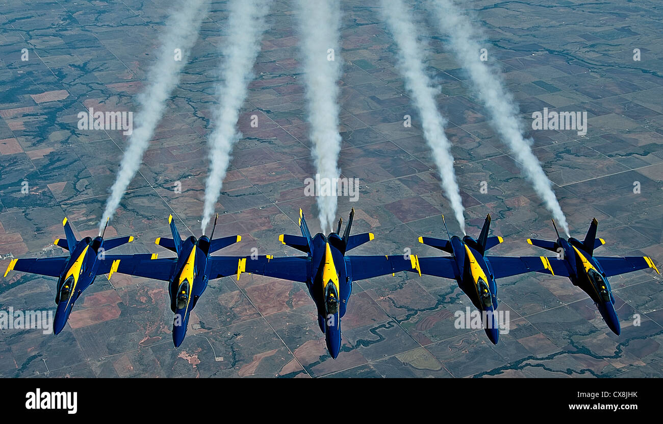 A formation of Navy Blue Angel FA-18 Hornets from Naval Air Station Pensacola, Fla., fly together after being refueled by a KC-135 Stratotanker from Altus AFB, Sept. 20, 2012. Aircrew from the 54th Air Refueling Squadron at Altus AFB refueled the Blue Angels on the way to Grand Juction, Colo., to perform in the First Mountain West Airshow. The Blue Angels travel 300 days out the year to perform aerial stunts for audiences nation wide. Stock Photo
