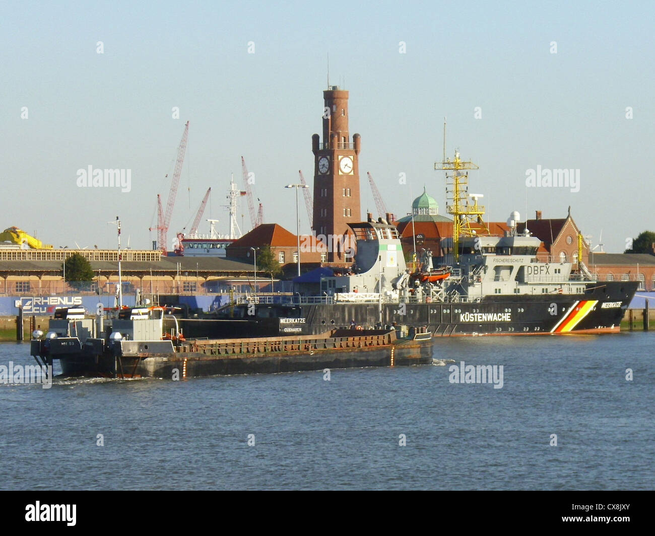 The self-propelled hopper barge '''HH 53''' (MMSI 211247310) and the fishing control vessel '''Meerkatze''' in the port of Cuxhaven, Germany Stock Photo