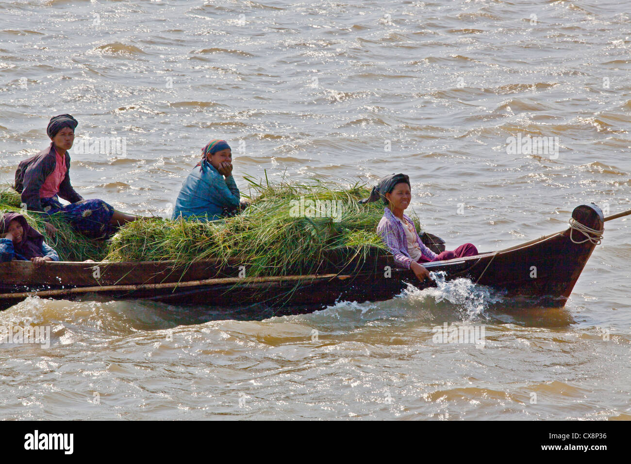 Transporting grass on the IRRAWADDY RIVER - MANDALAY, MYANMAR Stock Photo