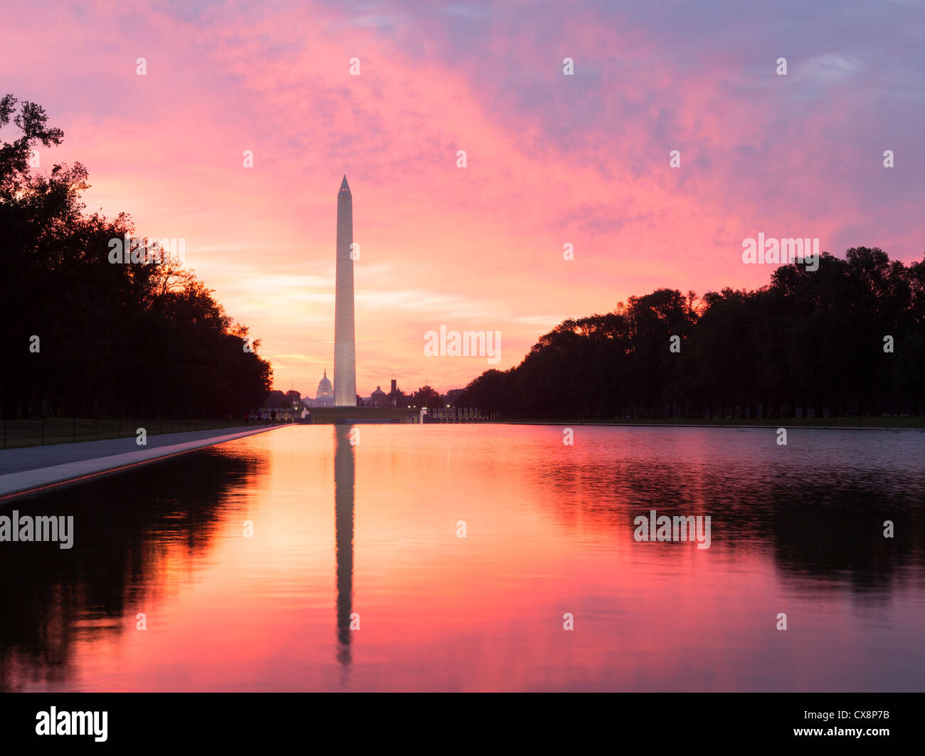 Sunrise at dawn reflects Washington Monument in new reflecting pool by Lincoln Memorial, USA with red sky Stock Photo