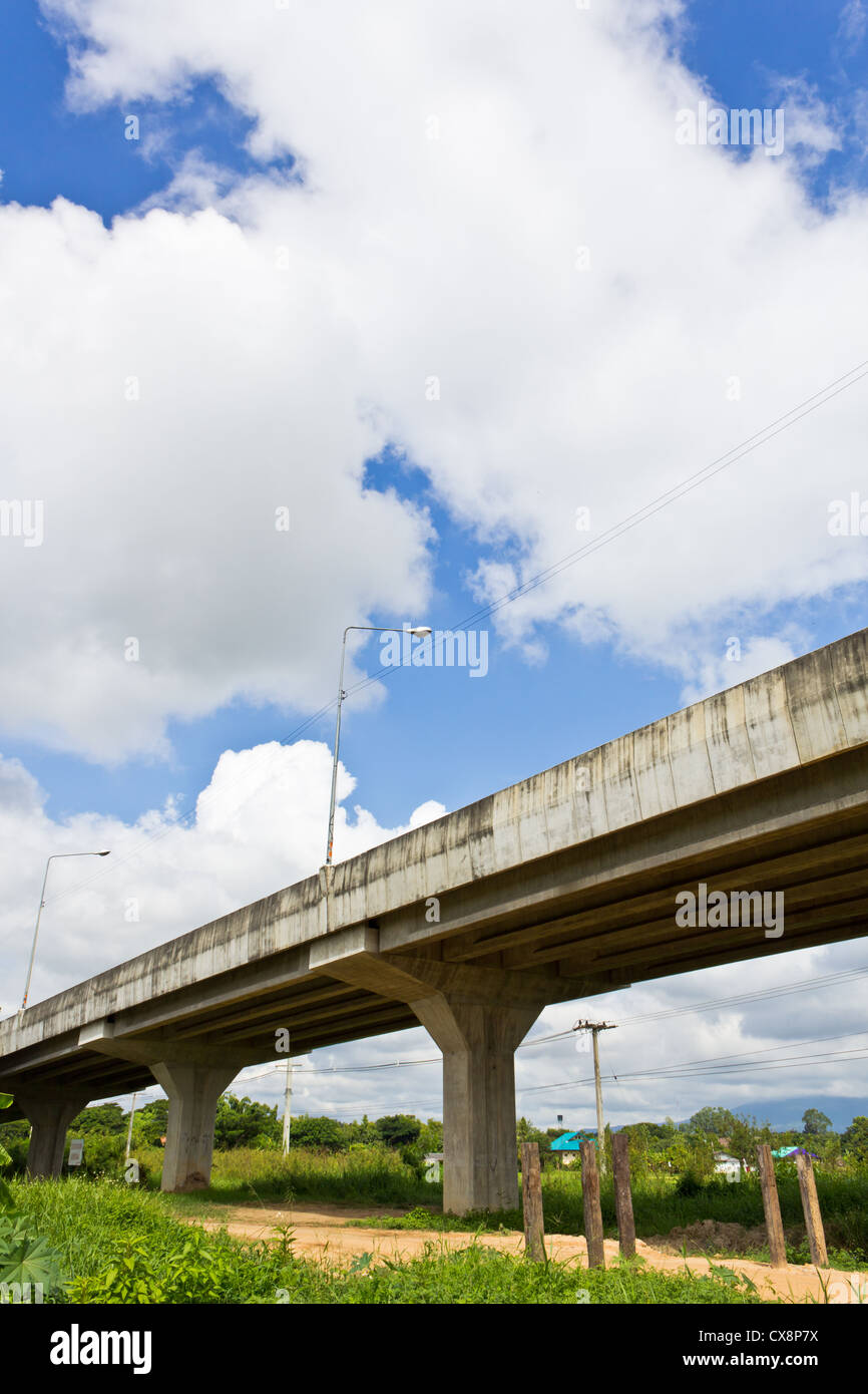 Non-Asphalt Road Under Bypass Road Leading to the City. Stock Photo