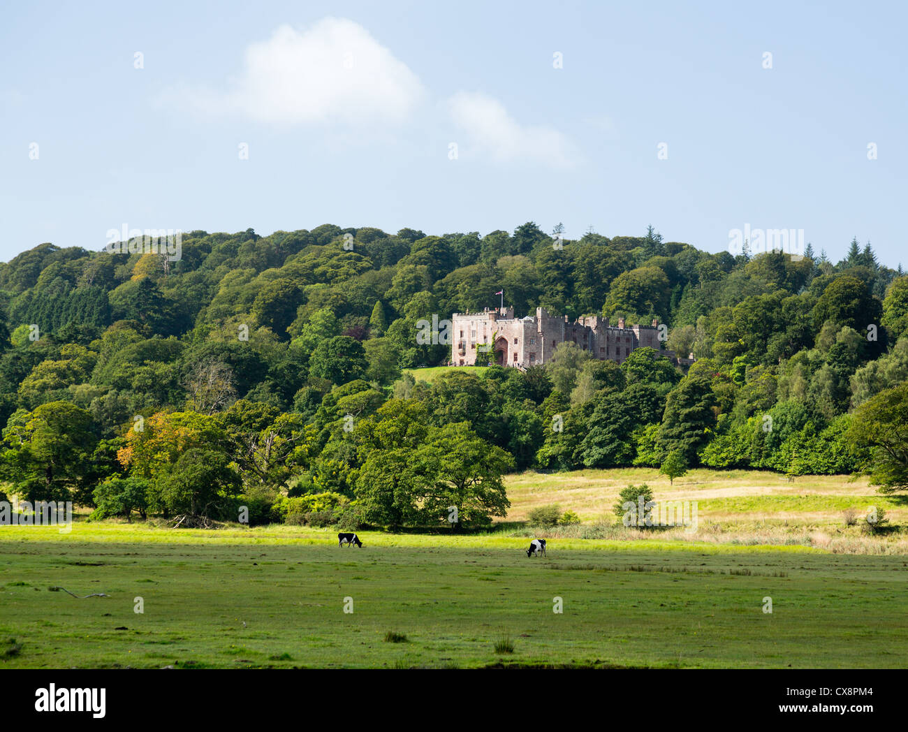 Muncaster Castle nestles in woodland on the edge of Lake District in England Stock Photo