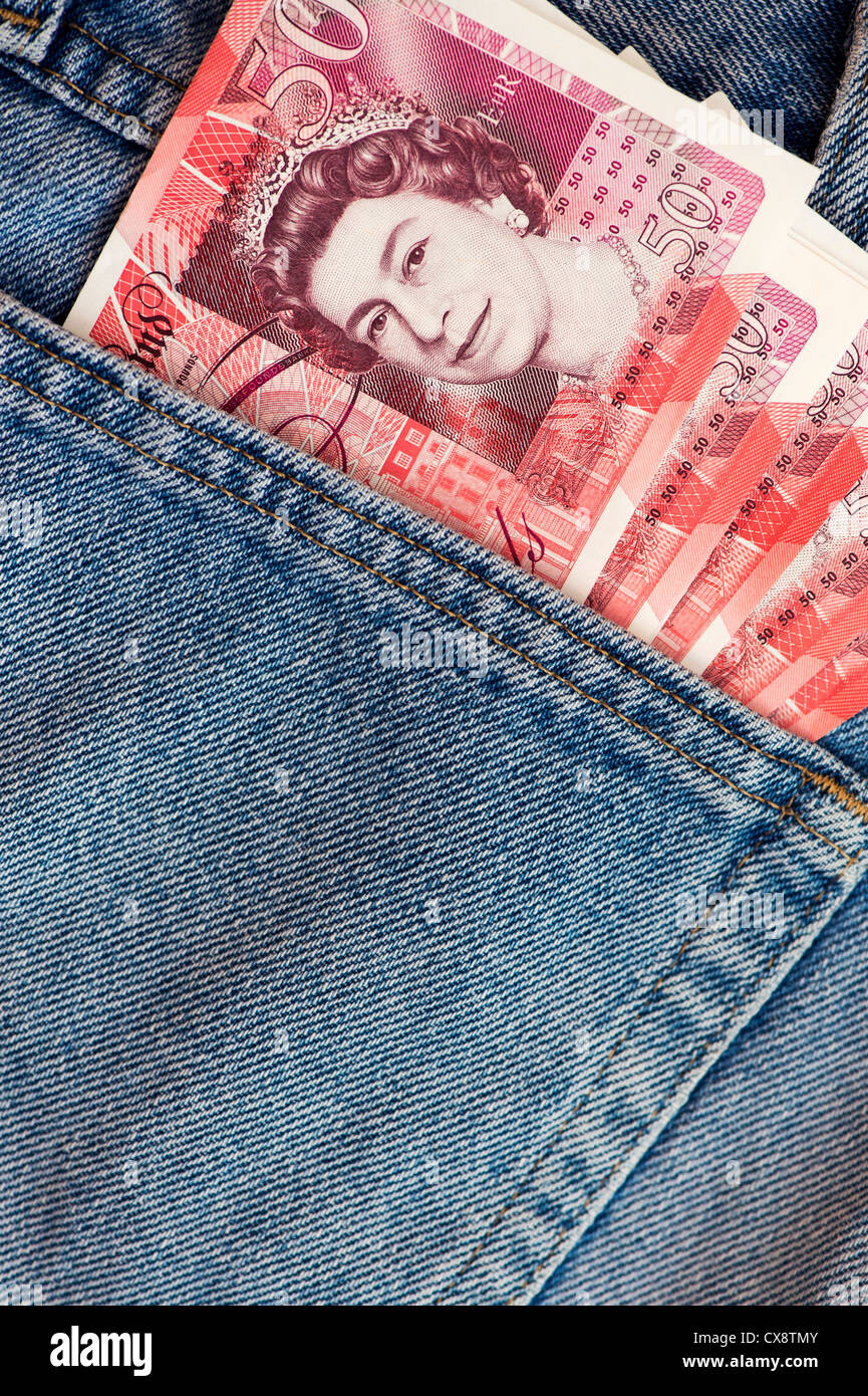 Fifty pound notes sterling in jeans back pocket Stock Photo