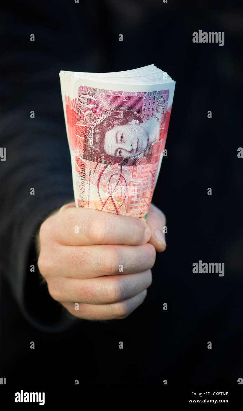 Hand holding Fifty pound notes sterling Stock Photo