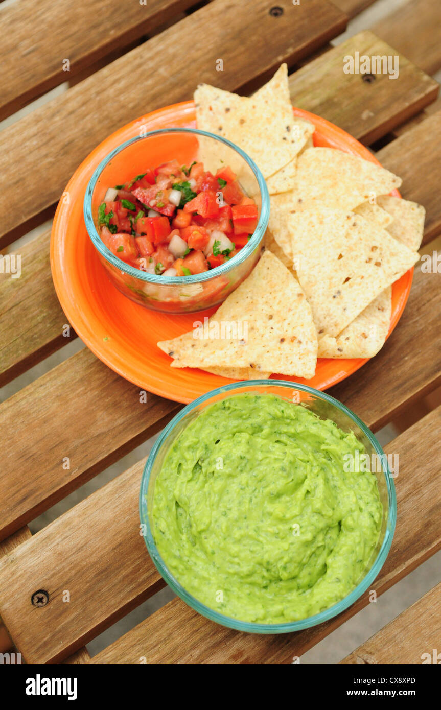 Guacamole dip with chips and salsa Stock Photo Alamy