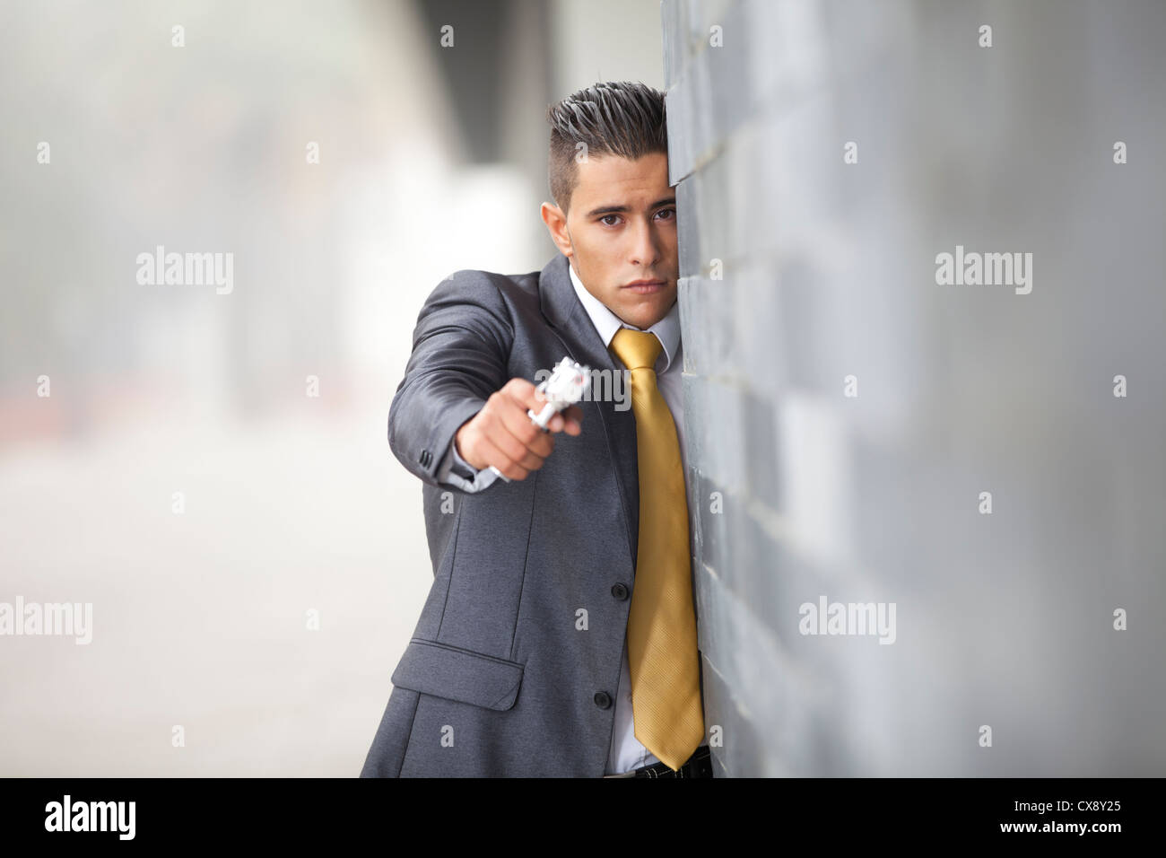 Powerful security businessman aiming a gun Stock Photo