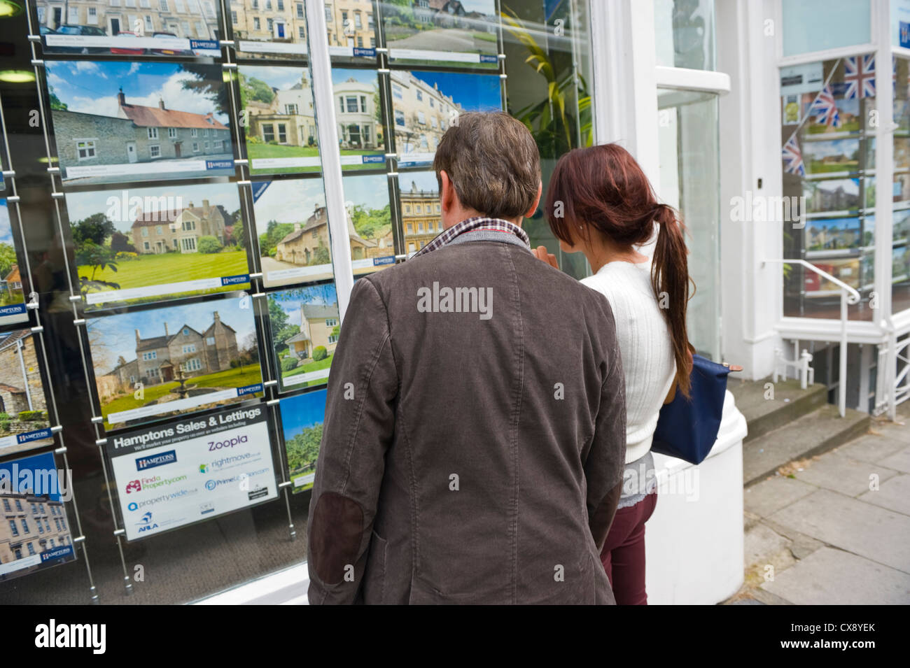 People looking in estate agents window in Bath Somerset England UK