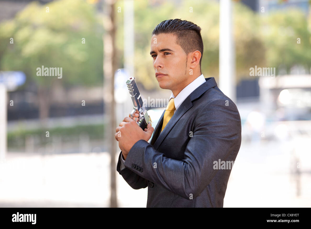 Powerful security businessman aiming a gun Stock Photo