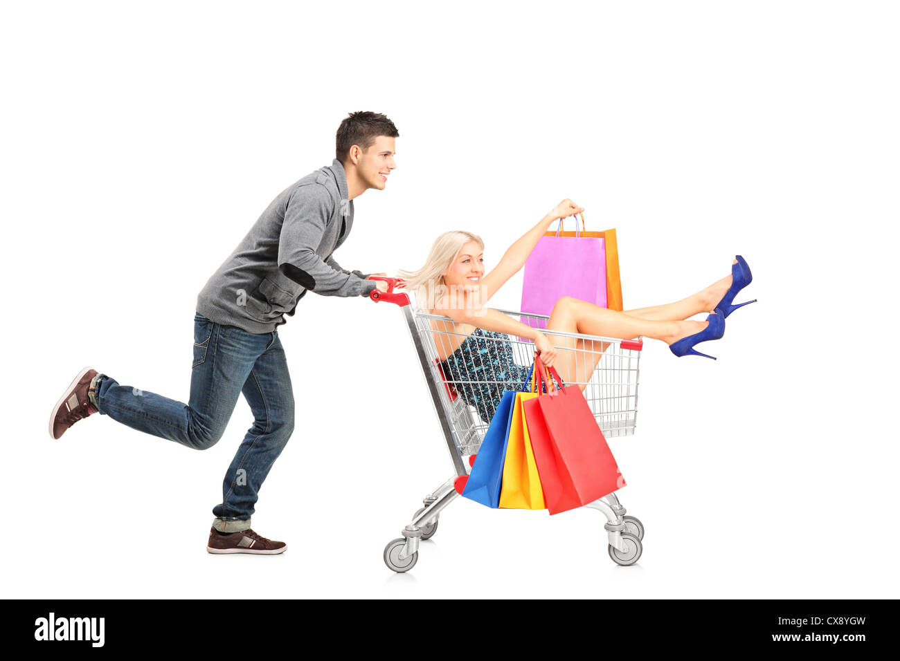 Person pushing a shopping cart, happy woman with bags in it, isolated