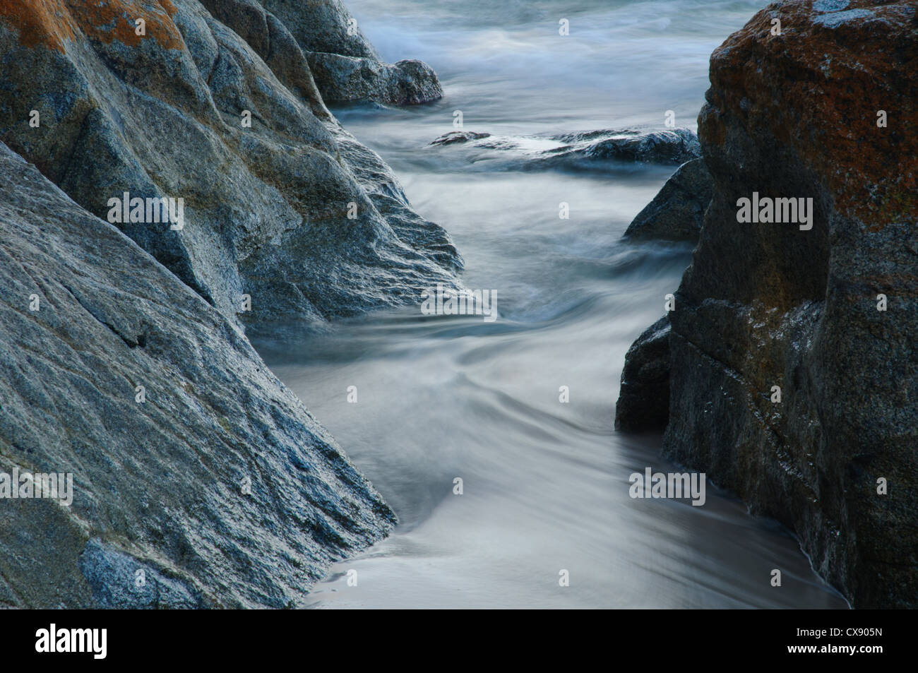 Flow Between Rocks Flow of sea water between rock formation Stock Photo - Alamy