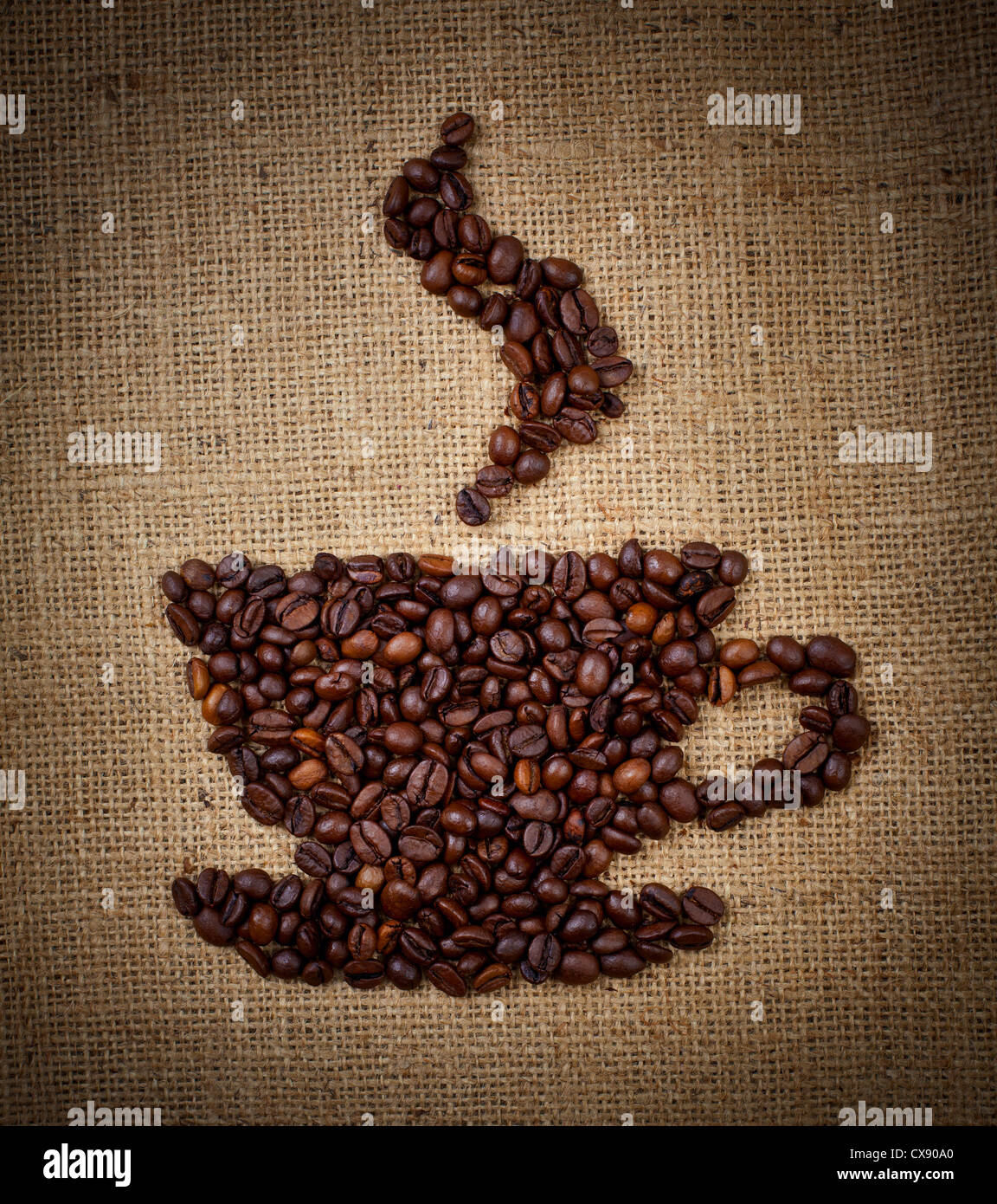 coffee cup made from beans on burlap background Stock Photo