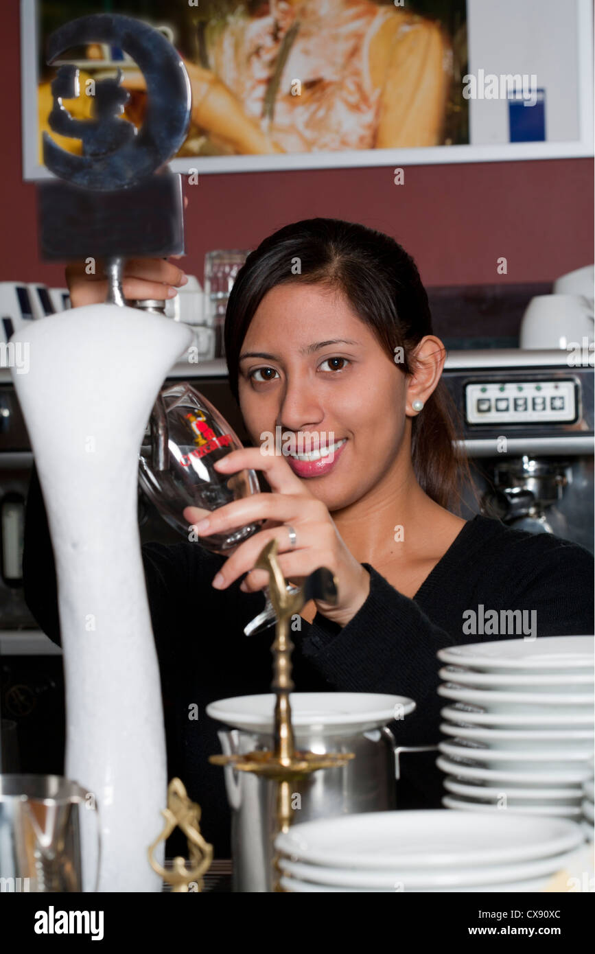waitress pours beer Stock Photo