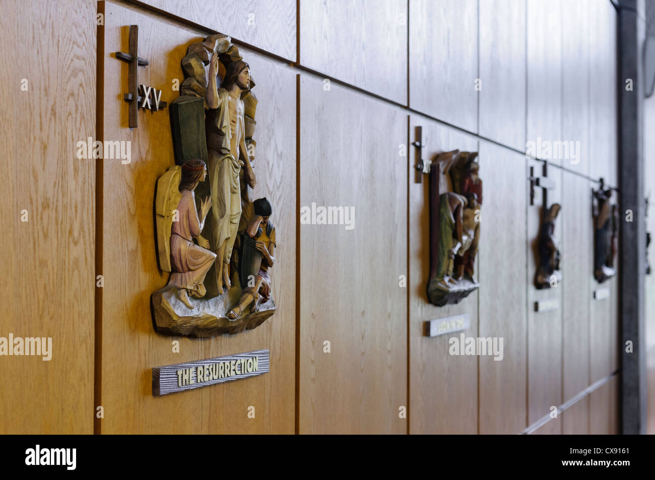 Wooden carvings on the wall of a monastery depicting some of the 14 Stations of the Cross Stock Photo