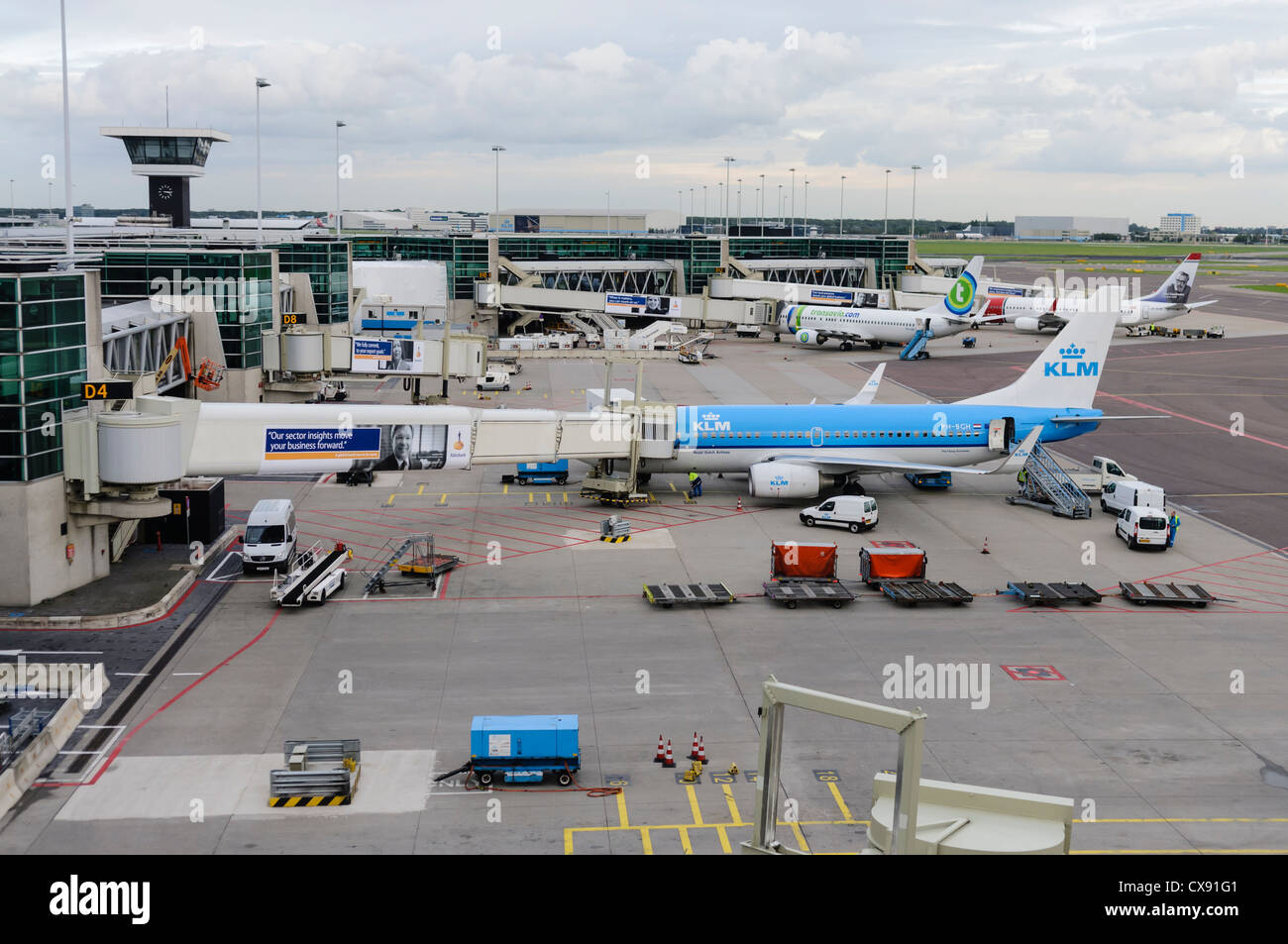Air France KLM planes on the apron of Amsterdam Schiphol Airport with service vehicles Stock Photo