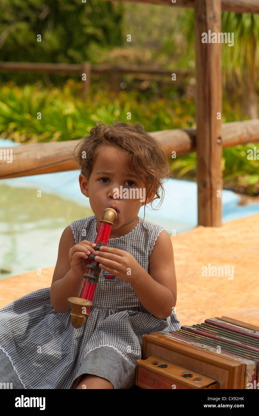 Cute girl in a park playing with vintage instruments Stock Photo