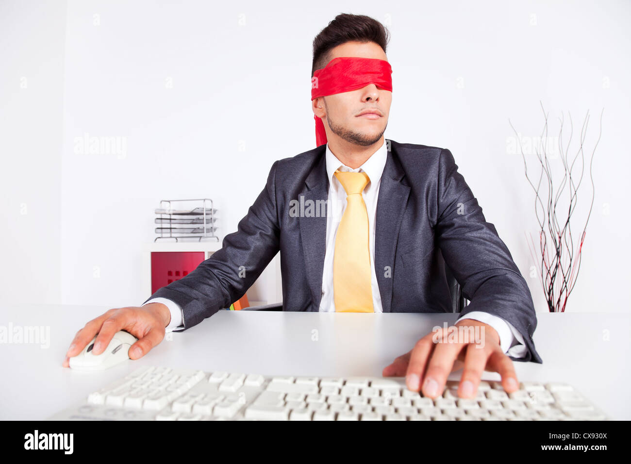 Businessman at his office with scarf covering his eyes while working ...
