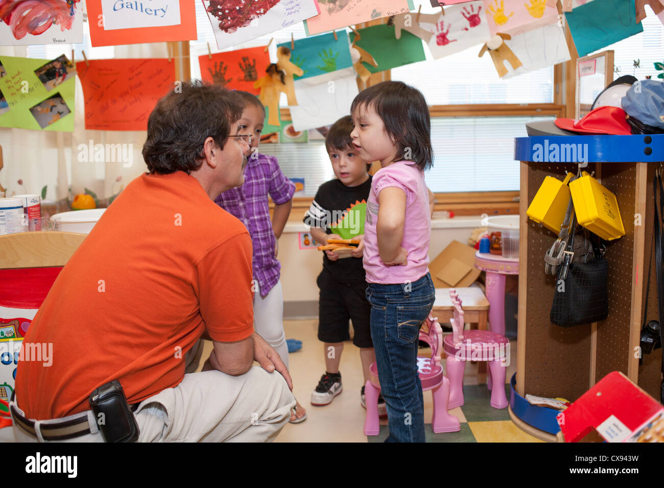 male preschool teacher talking with girl student Stock Photo - Alamy