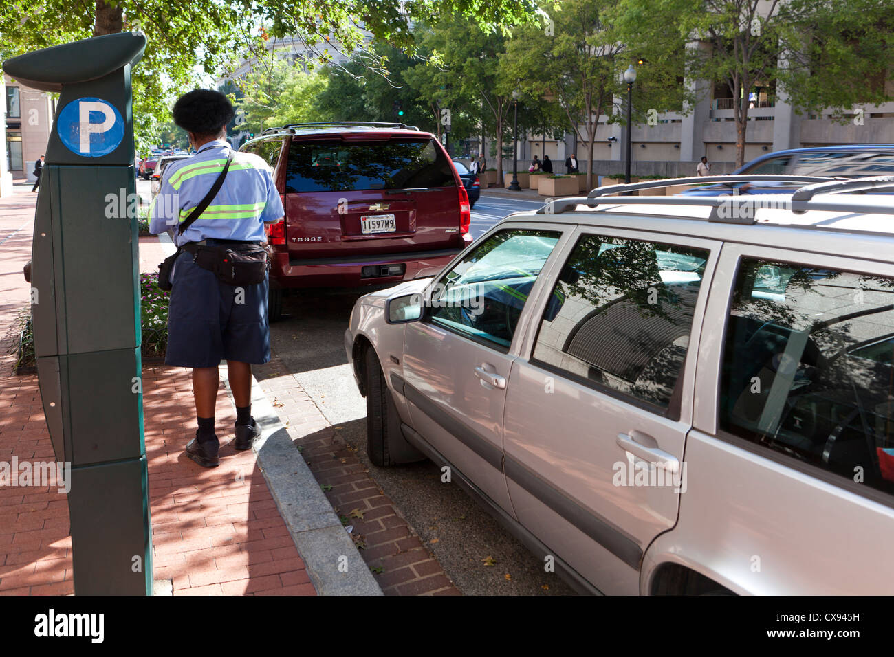 A parking enforcement officer writing a ticket - Washington, DC USA Stock Photo