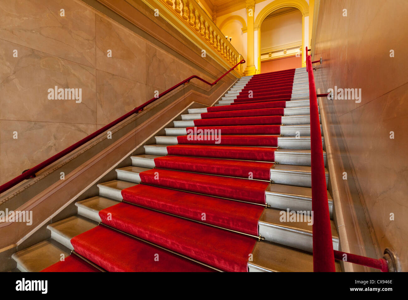 Red carpet lined marble staircase Stock Photo