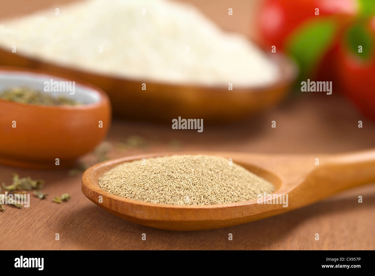 Basic ingredients of a pizza Active dry yeast on wooden spoon with