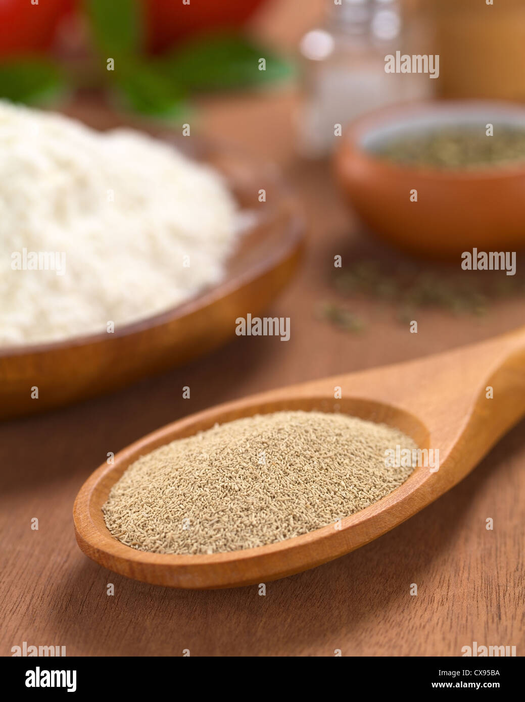 Basic ingredients of a pizza Active dry yeast on wooden spoon with