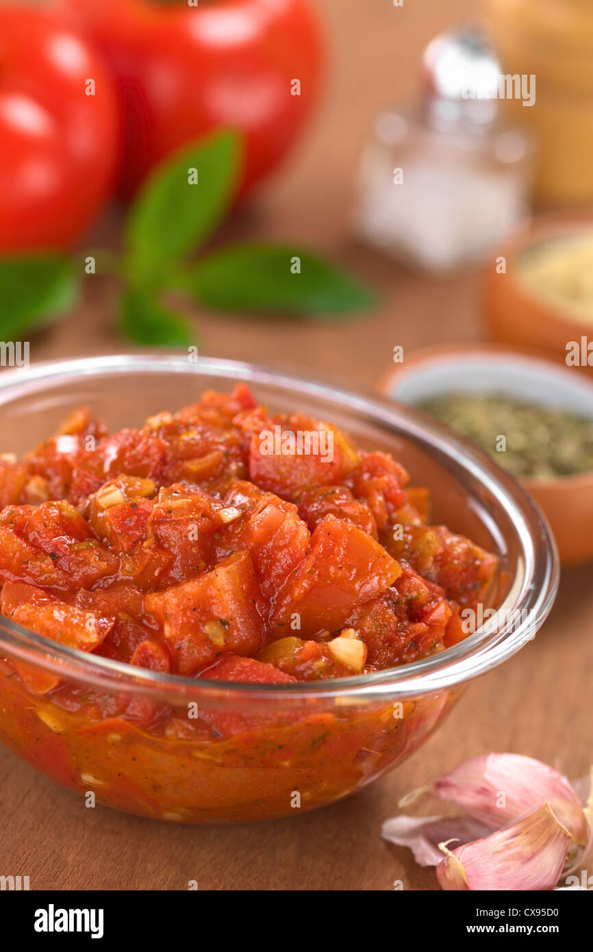 Glass bowl of fresh homemade tomato sauce for pizza made of fresh tomatoes, basil, garlic and oregano Stock Photo