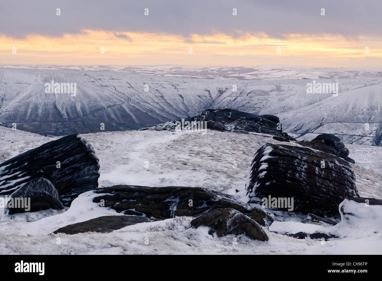 A snow scene at sunset. A Winter landscape view over the Vale of Edale from Kinder Scout, Derbyshire, Peak District National Park, England, UK Stock Photo