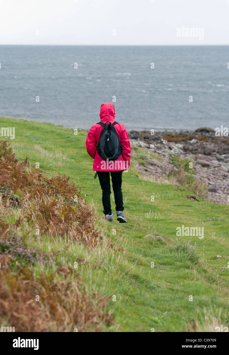Rear View Of A Person Woman Walking In The Rain Wearing A Red ...