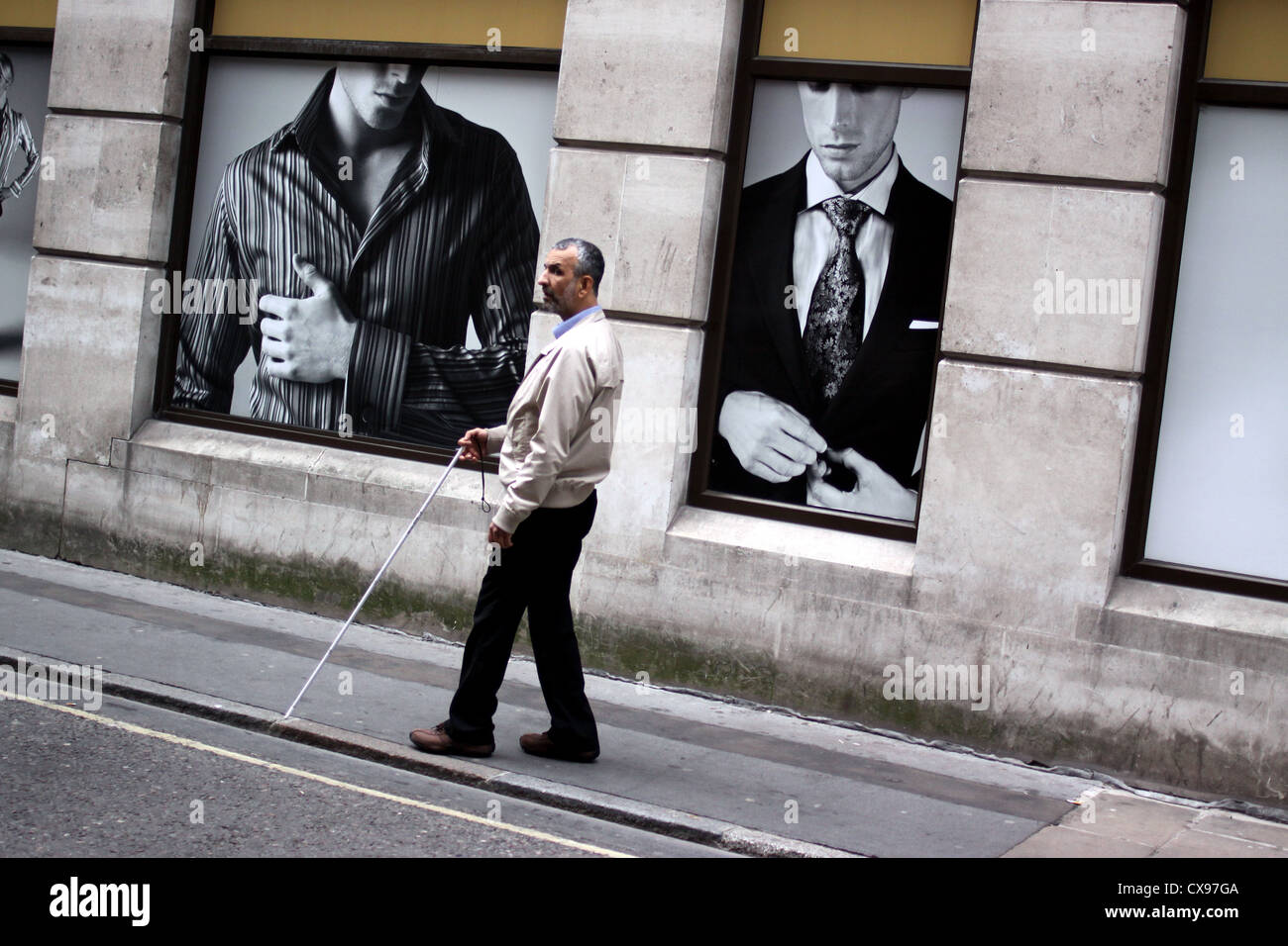 Blind man walking along the pavement near Mansion House in London Stock Photo