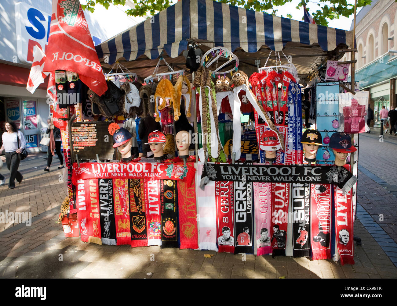 Stall holder selling Liverpool football club memorabilia St Johns Shopping precinct Liverpool 1 Stock Photo