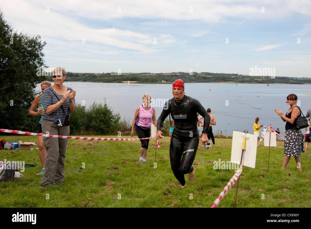 Swimmer in Triathlon event at Roadford Lake in Devon runs towards ...