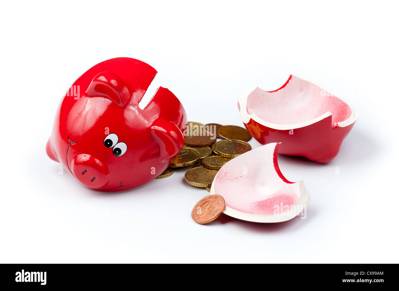 Broken piggy bank or money box with coins isolated on white Stock Photo