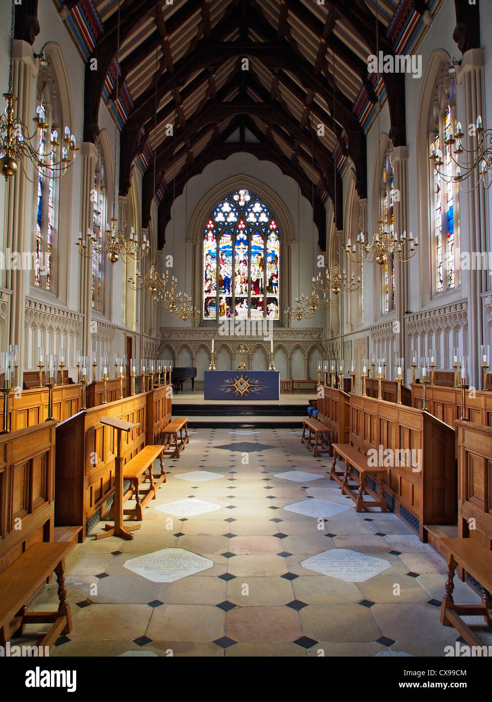 A portrait image showing the interior of the Chapel at Corpus Christi College in Cambridge with vaulted beamed ceiling and stain Stock Photo