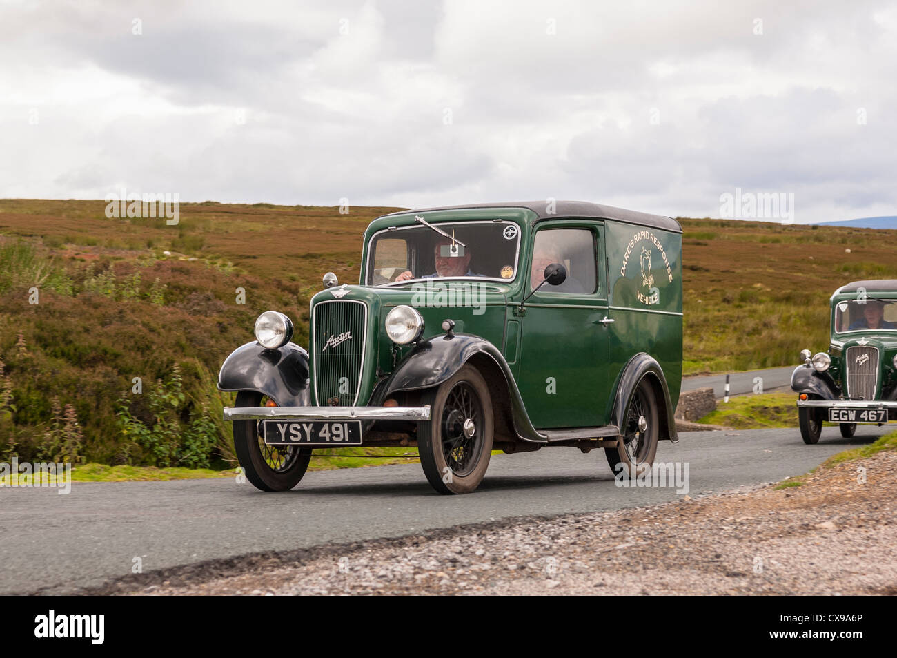A vintage Austin 7 classic car driving through the Yorkshire Dales showing movement in Yorkshire , England , Britain , Uk Stock Photo