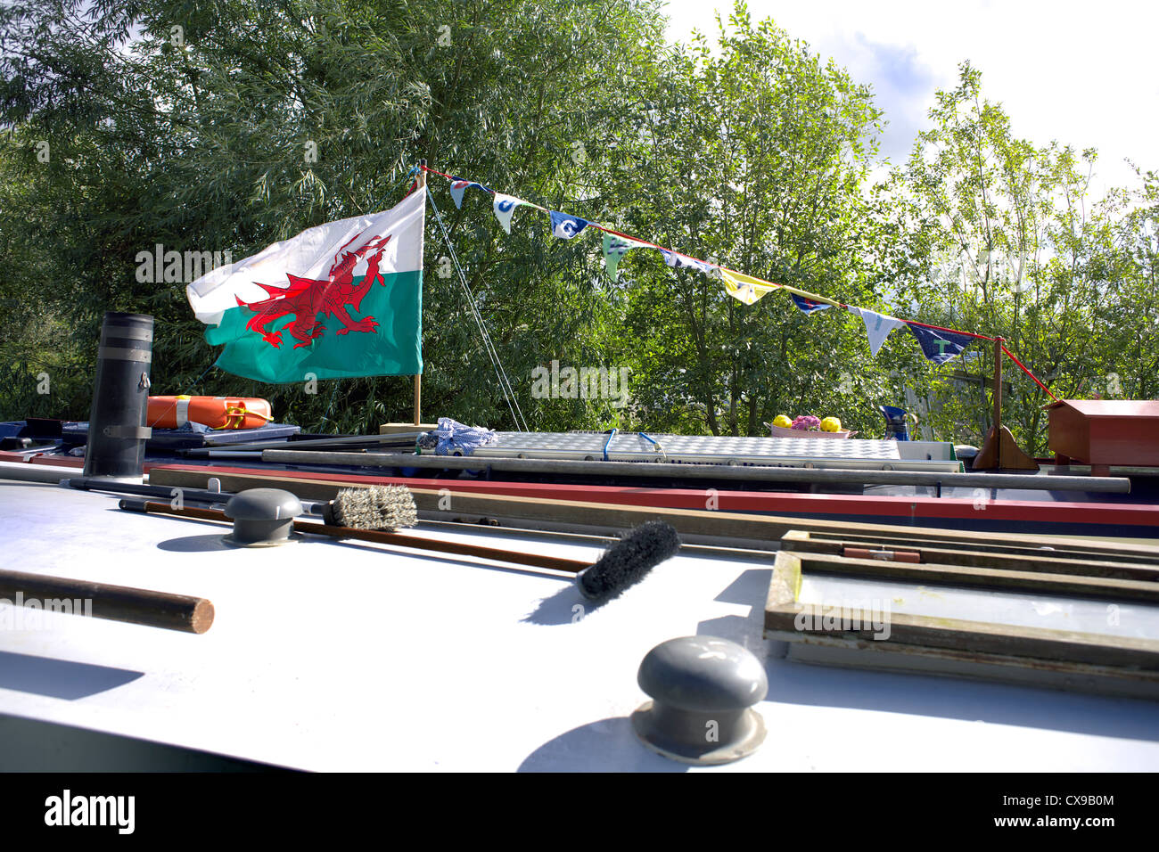 Welsh flag on the roof of a narrowboat, narrow, boat, Baner Cymru or Y Ddraig Goch, The Red Dragon Stock Photo