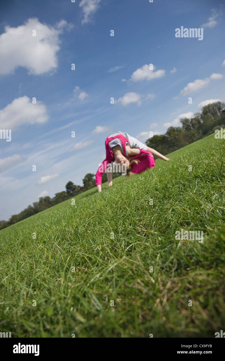 Young girl playing on a grass field Stock Photo - Alamy